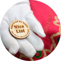 Hand holding token with "Nice List" written on it.