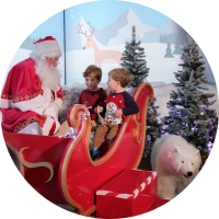 Santa with children in Santa's sleigh
